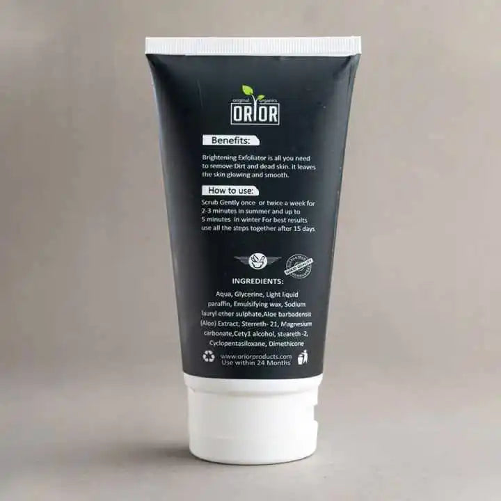 Facial scrub bottle is shown against dark brown background. this bottle is showing brightening exfoliator benefits and its uses