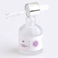Hyaluronic Acid Serum with open dropper lid against white background. Here the dropper is on the bottle in  horizontal position and one drop of hyaluronic acid serum is dropping down