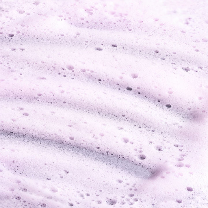 Orior Cosmetics Kojic Acid Foam Cleanser with a light purple, airy, and bubbly texture for gentle skin exfoliation.